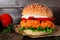 Healthy plant based cauliflower burger with buffalo sauce close up against a dark background