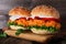 Healthy plant based cauliflower burger with buffalo sauce on a serving board against a wood background