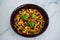 Healthy plant-based food, shell pasta with dairy-free mushroom sauce capsicum and basil