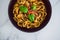 Healthy plant-based food, shell pasta with dairy-free mushroom sauce capsicum and basil