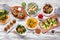 Healthy plant based low carb food table scene. Top down view on a white wood background.