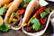 Healthy, plant-based meatless portobello mushroom steak fajitas, close up on a dark background