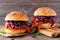 Healthy, plant based meatless pulled carrot burgers against a dark wood background