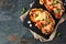 Healthy plant-based vegetarian cauliflower parmesan, above view serving scene on a slate background