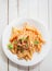 Healthy plate of Italian penne pasta with basil