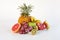 Healthy platter of whole mixed fruit on white background