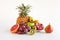 Healthy platter of whole mixed fruit on white background