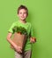 Healthy positive happy child with paper shopping bag full of fre