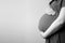 healthy pregnancy. side view pregnant woman with big belly advanced pregnancy in hands. Banner copyspace for text