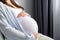 healthy pregnancy. Side view pregnant woman with big belly advanced pregnancy in hands. Banner copyspace for text