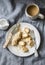 Healthy protein snack, breakfast - peanut butter, seeds, banana nut bites on a grey background