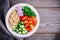 Healthy Quinoa Tabbouleh Salad bowl with fresh cucumbers, tomatoes and red onions