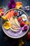 Healthy rainbow smoothie bowl topped with superfoods and edible blooms
