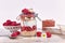 Healthy raspberry fruit dessert with skyr yogurt, granola and puffed quinoa grains layered in jar surrounded by ingredients