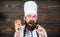 Healthy raw food. Dieting concept. Man wear hat and apron hold tomato. Healthy nutrition. Bearded hipster professional