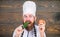 Healthy raw food. Dieting concept. Man wear hat and apron hold tomato. Healthy nutrition. Bearded hipster professional