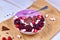 Healthy red fruit smoothie bowl decorated with raspberry, cranberry, small marshmallows and chocolate pieces