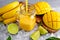 Healthy ripe Yellow Banana Mango Smoothie with slices of Lime, mint and ice