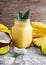 Healthy ripe Yellow Pineapple, coconut, banana Smoothie with slices of Lime and ice. concept healthy food