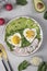 Healthy romantic breakfast - heart-shaped fried eggs served with avocado and radish, Vertical format