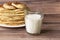 Healthy rustic food. Milk in a bottle, a glass and hot cakes for breakfast. Wheat, corn flour cakes. Wood background.