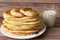 Healthy rustic food. Milk in a bottle, a glass and hot cakes for breakfast. Wheat, corn flour cakes. Wood background.