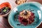 Healthy salad of beets, prunes and nuts on wooden background. Vegan food.