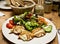 Healthy salad and bread on wood table