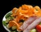 Healthy salad of ham, tomatoes, carrots, etc. on clean black background.