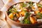 Healthy salad with persimmon, arugula and cheese close-up