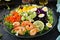 Healthy salad plate. Fresh seafood recipe. Grilled shrimps and fresh vegetable salad - avocado, tomato, black beans, red cabbage a