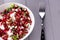 Healthy salad with pomegranate seeds, almond, feta cheese and black rice