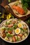 Healthy salad with salmon, potatoes, eggs and ruccola.