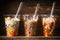 Healthy salads in plastic cups with fork on dark rustic background, side view.