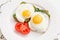 Healthy sandwiches with spinach fried eggs and tomato on a white plate.