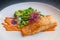 Healthy Scandinavian meal of salmon fillet with broccoli, young beans and spicy red sauce