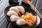 Healthy seafood meal: Chinese dumplings with shrimp close-up served with vegetable salad and soy and tomato sauces. horizontal