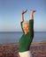 Healthy senior woman practicing yoga on beach