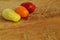 Healthy and shiny cherry tomatoes of different colors on a rustic cutting board.