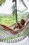 Healthy sleep in the open air at hammock. Sexy woman relaxing