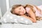 Healthy sleep tips. Girl sleep on little pillow bedclothes background. Kid long curly hair fall asleep pillow close up
