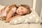 Healthy sleep tips. Girl sleep on little pillow bedclothes background. Kid long curly hair fall asleep pillow close up