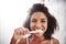 Healthy smiles are the best smiles. Portrait of an attractive young woman brushing her teeth in the bathroom at home.