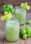 Healthy smoothie with green grape, lemon and honey in glass