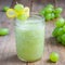 Healthy smoothie with green grape, lemon and honey in glass jar, square