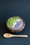 Healthy smoothie , plate made from coconut shell on dark background