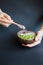 Healthy smoothie , plate made from coconut shell on dark background