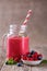 Healthy smoothie with raspberries, berries on plates and drinking straws.