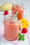 Healthy smoothie with strawberry, mango and banana in glass jars