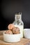 Healthy snack. Energy ball with date plam, black and white sesame, chia and rasin in ceramic bowl on wooden table. Vegan